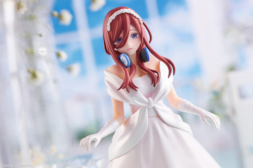 Miku Nakano figure in a classic white bridal dress, holding a bouquet, with a serene expression and a delicate pose.
